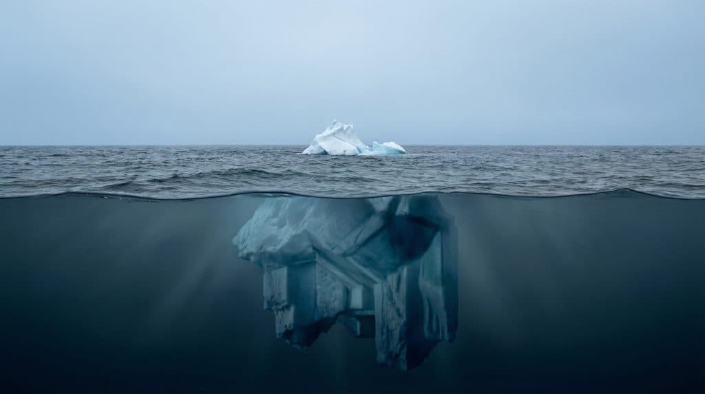 An iceberg showing the much larger structure below the visible surface